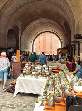 This image shows that the Brooklyn Flea Market is an outdoor market offering unique finds such as vintage clothing, handmade goods, antiques, and delicious local food, making it a treasure trove for eclectic shoppers.