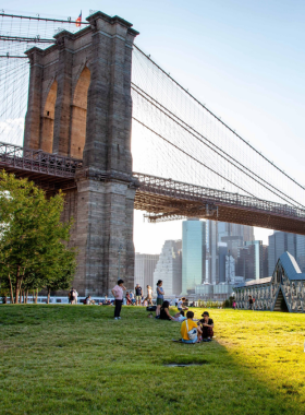 This image shows that Brooklyn Bridge Park is an expansive waterfront park offering stunning views, recreational activities, bike rentals, and picnic spots, providing a relaxing escape from the city's hustle and bustle.