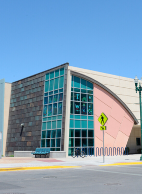 "This image shows the interior of the El Paso Public Library, with rows of bookshelves filled with a diverse collection of books, providing visitors with a place for learning, reading, and engaging in community programs and educational activities."