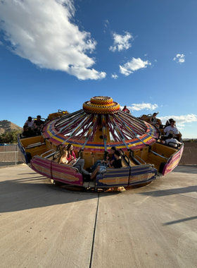 This image shows the exciting rides at Western Playland Amusement Park, featuring a roller coaster and other thrill rides, offering fun and entertainment for families and visitors of all ages in El Paso’s iconic amusement destination."