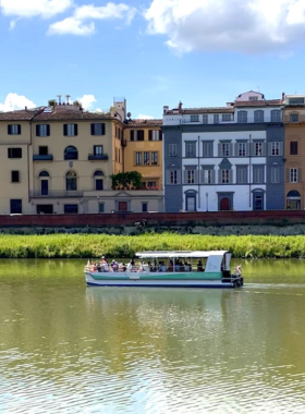 This image shows a serene Arno River cruise, with the iconic Ponte Vecchio, the Uffizi Gallery, and the Duomo visible in the background. The boat ride offers stunning views of Florence from the water.