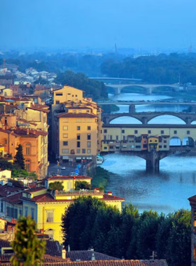 This image shows the stunning panoramic view of Florence from Piazzale Michelangelo. The square offers a magnificent view of the city, including landmarks like the Duomo and the Arno River, especially at sunset.