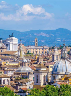 This image shows a beautiful sunset view from Gianicolo Hill in Rome. It offers panoramic views of the city, including landmarks like St. Peter’s Basilica and the Colosseum.