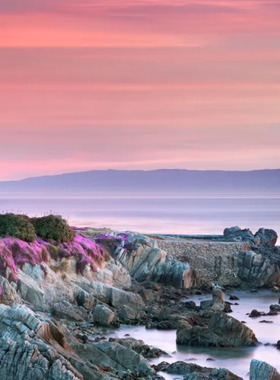 This image shows the beautiful coastal view of Pebble Beach, featuring its world-famous golf courses along with scenic beaches and luxurious resorts that define this premier coastal destination.