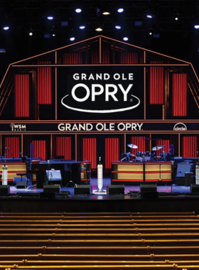 Grand Ole Opry This image shows a live performance at the Grand Ole Opry, a historic venue in Nashville where country music legends like Dolly Parton and Johnny Cash performed. The stage is illuminated with bright lights, creating an exciting atmosphere for music lovers.