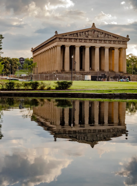 6. Centennial Park This image shows Centennial Park in Nashville, with its famous full-scale replica of the Parthenon. Visitors stroll through the park, enjoying the peaceful surroundings, walking trails, and beautiful gardens, making it a perfect spot for relaxation and recreation.