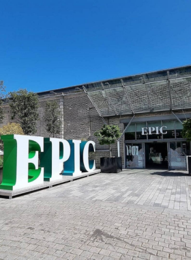 This image shows visitors exploring EPIC – The Irish Emigration Museum in Dublin, featuring interactive exhibits and multimedia displays. The image highlights stories of Irish emigrants and their global contributions in fields like science, politics, and art.