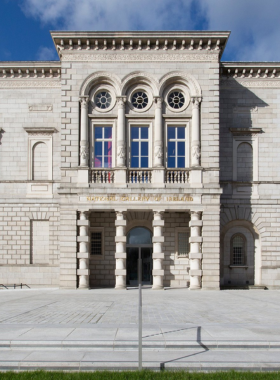 This image shows the National Gallery of Ireland, where visitors are admiring beautiful European and Irish artwork. The image captures grand exhibition halls with famous paintings, sculptures, and educational displays in a calm setting.