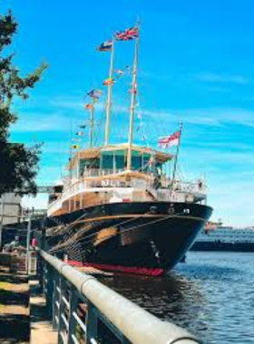 This image shows the Royal Yacht Britannia docked at Leith, Edinburgh. It highlights the elegant exterior of the former royal ship that once carried the British royal family on state visits and personal journeys.