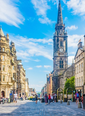 This image shows Edinburgh’s Royal Mile, a historic street with medieval buildings, lively shops, street performers, and historic landmarks, connecting Edinburgh Castle to the Palace of Holyroodhouse.