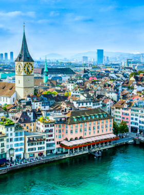 This image shows a relaxing pedalo ride on Lake Zurich with beautiful views of the city and surrounding mountains. The clear blue water and scenic landscape make it a perfect outdoor activity to enjoy in Switzerland.