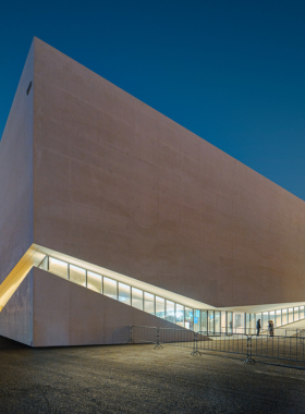 This image shows the exterior of the Plateforme 10 museum in Lausanne, Switzerland. The modern building features innovative architecture and is a hub for contemporary art exhibitions and cultural events.