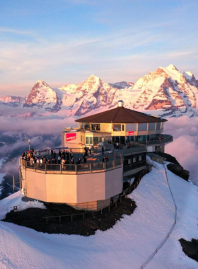 This image shows the panoramic view from the revolving restaurant at Schilthorn. Visitors dine while enjoying breathtaking 360-degree views of the Swiss Alps, making it an unforgettable experience for all who visit.