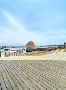 This image shows the picturesque Quietwater Beach Boardwalk, offering a peaceful spot to walk along the Gulf Coast. The boardwalk stretches alongside the beach, providing visitors with stunning views of the water, nearby shops, and a relaxed atmosphere perfect for watching sunsets or enjoying a casual stroll.