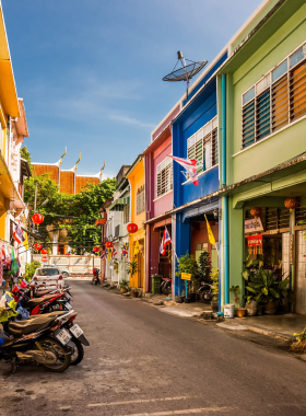 This image shows the vibrant, historic streets of Phuket Old Town, with its colonial Sino-Portuguese architecture, colorful buildings, and lively atmosphere, perfect for cultural exploration and photography.