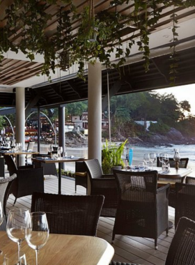 This image shows The Boathouse Restaurant in Phuket, offering an oceanfront dining experience where guests can enjoy fresh seafood and Thai delicacies with a beautiful view of the sea.