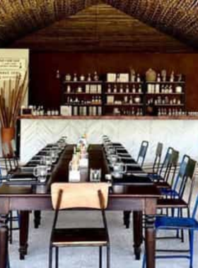 This image shows visitors enjoying a rum tasting session at Chalong Bay Distillery, where they learn about the rum-making process and sample handcrafted rum blends.