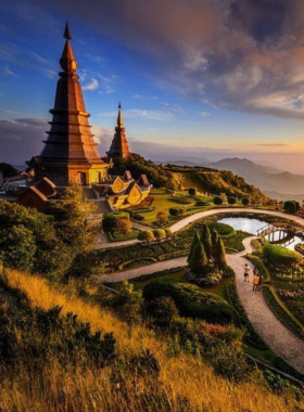 This image shows the lush green landscape of Doi Inthanon National Park, with misty mountains, cascading waterfalls, and a variety of birds and wildlife. The high-altitude views are perfect for nature and wildlife photographers.