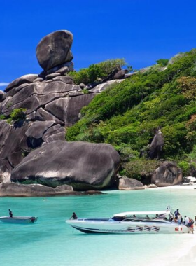 This image shows the serene and peaceful beaches of Ko Yao Noi, an island in Thailand. The tranquil waters and clear skies provide the perfect setting for a quiet, peaceful escape away from crowds.