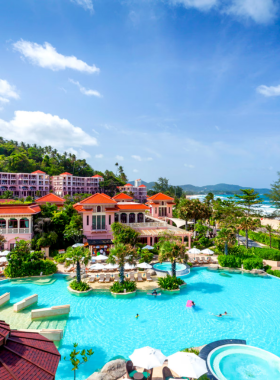 This image shows Centara Grand Beach Resort, nestled amidst lush greenery. Guests are seen relaxing in the resort's eco-friendly surroundings, enjoying the gym, free Wi-Fi, and beach access while supporting sustainable tourism practices.