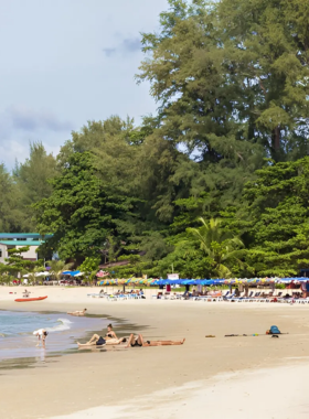 This image shows the peaceful Sirinat National Park, with visitors strolling along sandy beaches, swimming in clear waters, and enjoying the surrounding mangroves and wildlife. The park offers a tranquil escape, perfect for nature lovers looking to relax and explore Phuket’s natural beauty.