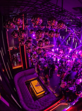 This image shows a thrilling hip-hop night at Sugar Club in Patong, Phuket. It features professional dancers performing on stage, vibrant laser lighting, and a crowd fully engaged with the energetic beats, illustrating the club's dedication to hip-hop culture.