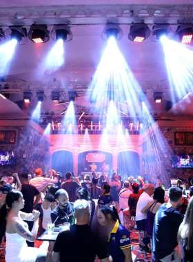 This image shows a vibrant party scene at Barfunk in Patong, Phuket. It features a lively crowd, colorful lighting, and DJs spinning energetic beats, emphasizing the bar’s dynamic and high-energy atmosphere for nightlife enthusiasts.