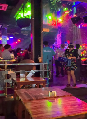 This image shows a live band performance at New York Bar in Phuket. The scene includes musicians passionately playing instruments, an engaged audience, and a warm-lit ambiance, making it a favorite spot for music lovers.