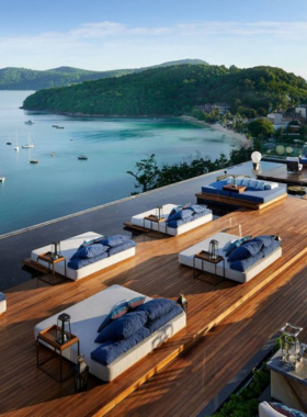 This image shows that Akoya Star Lounge in Phuket offers breathtaking coastal views from its rooftop. The image shows guests relaxing and enjoying the sunset as the golden hour lights up the sky, providing a beautiful scene for both landscape and lifestyle photography.