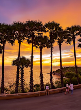 This image shows that Promthep Cape in Phuket is famous for its spectacular sunset views. The image captures the vibrant colors of the sunset over the Andaman Sea, with silhouettes of visitors enjoying the breathtaking view, making it a top destination for sunset photography.