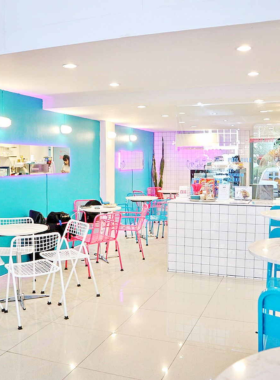 "This image shows the vibrant, colorful decor of Pooltime Cafe in Bangkok, offering a fun and Instagrammable atmosphere. The quirky, playful design makes it a unique spot to enjoy milkshakes, snacks, and refreshing drinks."