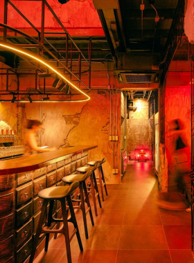 "This image shows Tai Soon Bar, a cozy craft beer bar in the heart of Bangkok, offering a relaxing retro vibe and a wide selection of craft beers, perfect for a laid-back evening with friends."