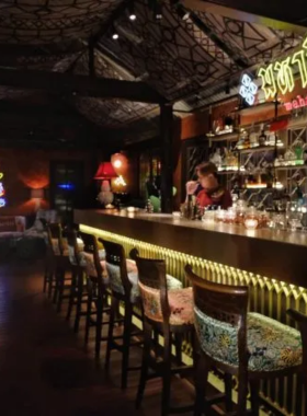 "This image shows Mahaniyom Cocktail Bar in Sathorn, Bangkok, a creative cocktail bar offering unique drinks made with ingredients like beef fat and blue cheese air, perfect for adventurous drinkers."