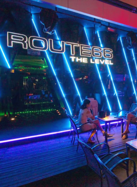 "This image shows Route 66, a popular nightclub in RCA, Bangkok, offering a huge dance floor, amazing DJs, and a mix of EDM, hip-hop, and pop music, making it an ideal place to party with friends."