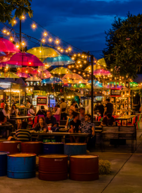 This image shows a bustling Chiang Mai night market, with colorful stalls offering handmade crafts, delicious street food, and live performances. Visitors can explore the vibrant atmosphere of the Sunday Night Market or the Night Bazaar, enjoying the lively ambiance and local culture late into the evening.