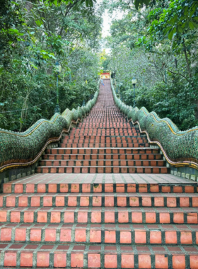 This image shows a peaceful hiker walking along the Monk’s Trail to Wat Pha Lat, a hidden temple nestled in the jungle. The trail offers a serene escape from the city, with lush greenery and stunning views, leading visitors to a tranquil spiritual retreat amidst nature.