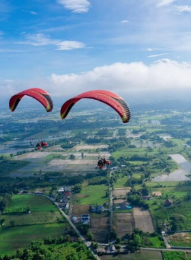 This image shows a paramotor soaring through the clear skies above Chiang Mai, offering breathtaking aerial views of the valleys, mountains, and natural landscapes that surround the city.