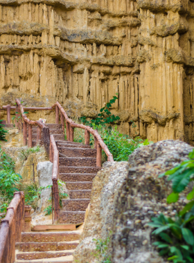 This image shows visitors exploring Pha Chor Gorge, marveling at the unique rock formations and towering cliffs while hiking along the trail, capturing the awe-inspiring natural beauty of this lesser-known gem in Chiang Mai.