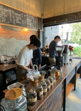 This image shows a refreshing glass of iced Thai coffee with herbal drinks served at Khagee café in Chiang Mai. The warm, welcoming setting makes it an ideal spot for enjoying traditional Thai beverages.