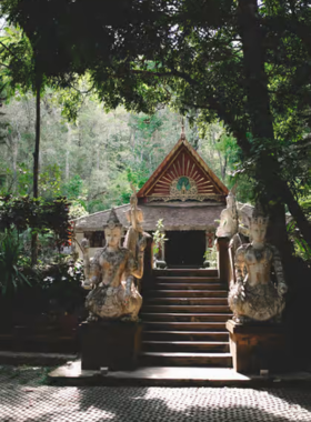 This image shows the serene Wat Pha Lat forest temple surrounded by lush greenery. The peaceful atmosphere is enhanced by natural elements like trees, stone pathways, and a flowing stream, making it an ideal place for meditation and reflection. The intricate carvings on the temple’s structures blend seamlessly with the forest, giving it a mystical and spiritual vibe that feels like a hidden sanctuary.