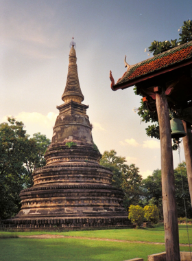 This image shows Wat Umong, the tunnel temple in Chiang Mai, with its ancient, moss-covered brick walls. The photo highlights the tunnel’s unique design and dimly lit interiors, where visitors can see old Buddhist murals. Outside, the peaceful garden and lake create a tranquil atmosphere for meditation and contemplation. The temple’s rustic and historical charm is perfectly captured, showcasing a mix of nature and spirituality.