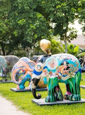 This image shows the colorful elephant statues at Elephant Parade Land, each uniquely hand-painted with intricate designs. Visitors admire the artistic creativity and learn about elephant conservation efforts. The vibrant display highlights the connection between art and environmental awareness. The cheerful and inspiring setting makes it an engaging experience for families and art enthusiasts alike.