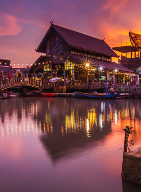 This image shows the lively atmosphere of Thepprasit Night Market in Pattaya, bustling with vendors selling street food, clothing, and local goods. The market is packed with visitors exploring the vibrant stalls, enjoying Thai delicacies, and shopping for unique items under the bright market lights.