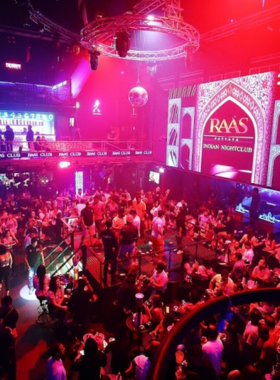 This image shows a lively Bollywood night at Raas Club in Pattaya, with a vibrant dance floor, colorful lights, and an enthusiastic crowd celebrating the music and energy.