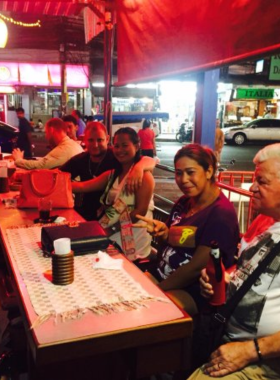 This image shows the cozy atmosphere of Madam T Pattaya, featuring a small yet lively bar setup, affordable drinks, and patrons enjoying a laid-back night out.