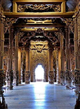 This image shows the magnificent wooden structure of the Sanctuary of Truth in Pattaya, Thailand. The detailed carvings and tall spires represent Eastern philosophies and religious beliefs, creating a visually stunning and peaceful atmosphere that attracts visitors for reflection and cultural exploration.