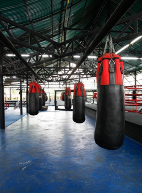 This image shows a participant engaging in a Muay Thai session at Kombat Group Fitness Camp in Pattaya. The camp specializes in martial arts and fitness training, providing a fun and intense way to stay fit while immersing in Thai culture through boxing and Muay Thai techniques.