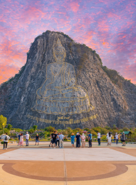 This image shows the grand golden Buddha engraving on Khao Chi Chan, surrounded by tranquil nature. The limestone mountain and serene environment make it a stunning cultural and natural landmark.