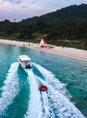 This image shows the untouched beaches and crystal-clear waters of Ko Phai, with seabirds and marine life adding to the island’s natural charm. It reflects the serene and pristine environment of this tropical paradise.