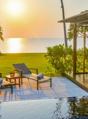 This image shows private luxury villas at Baan Taling Ngam Resort, perched on a hillside overlooking the Gulf of Thailand. With a focus on eco-sustainability, the resort offers organic dining and wellness programs in a natural, serene setting.